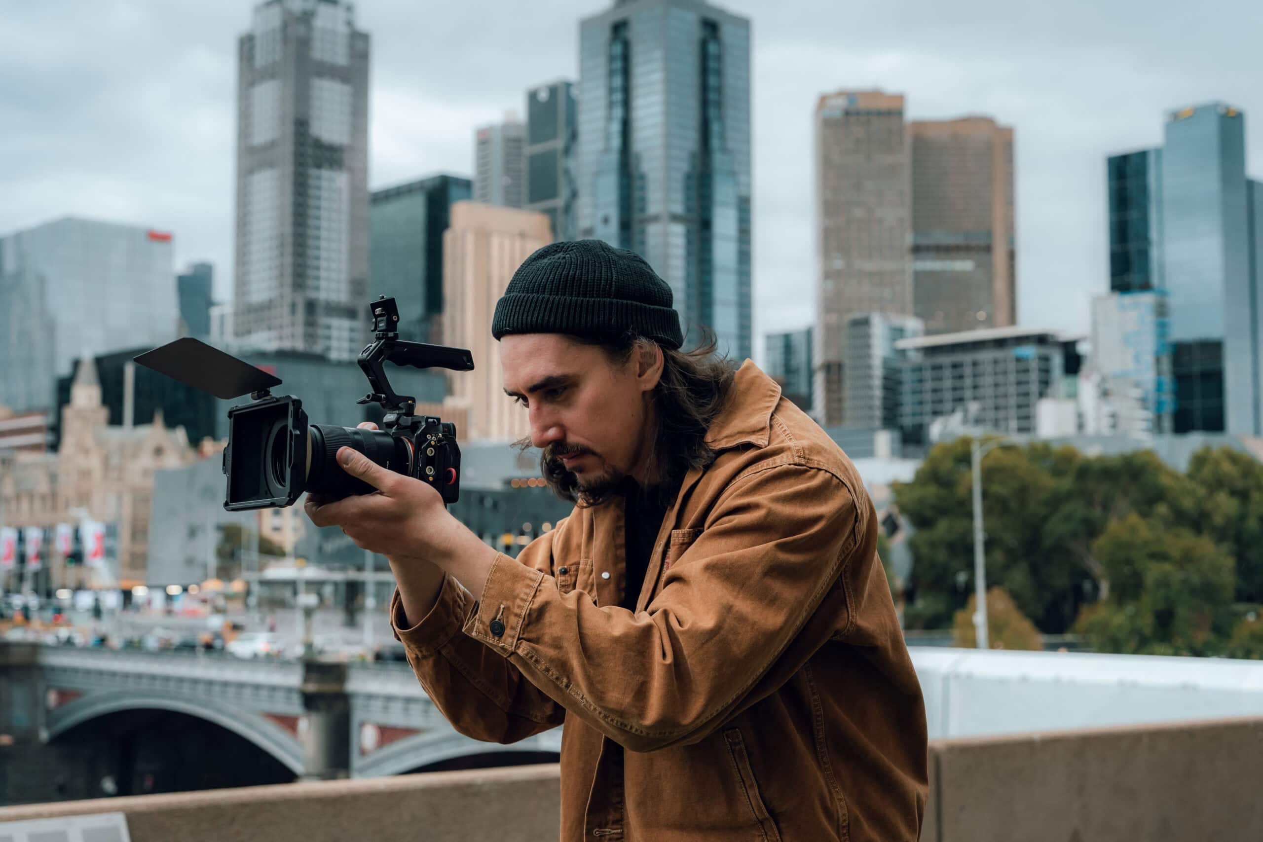dymon creative – close-up of filmmaker recording with camera in Melbourne city