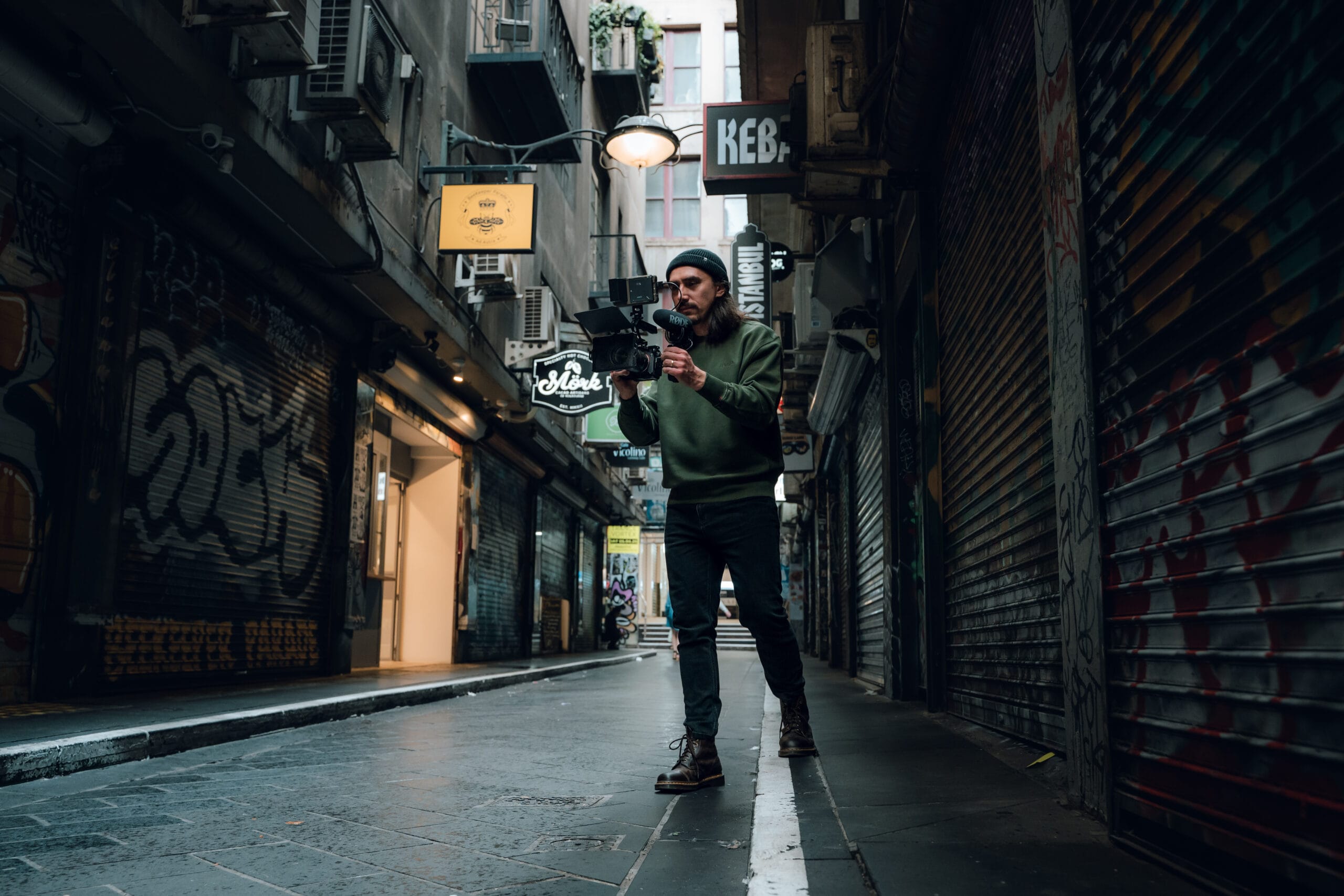 dymon creative – filmmaker recording shot and checking monitor