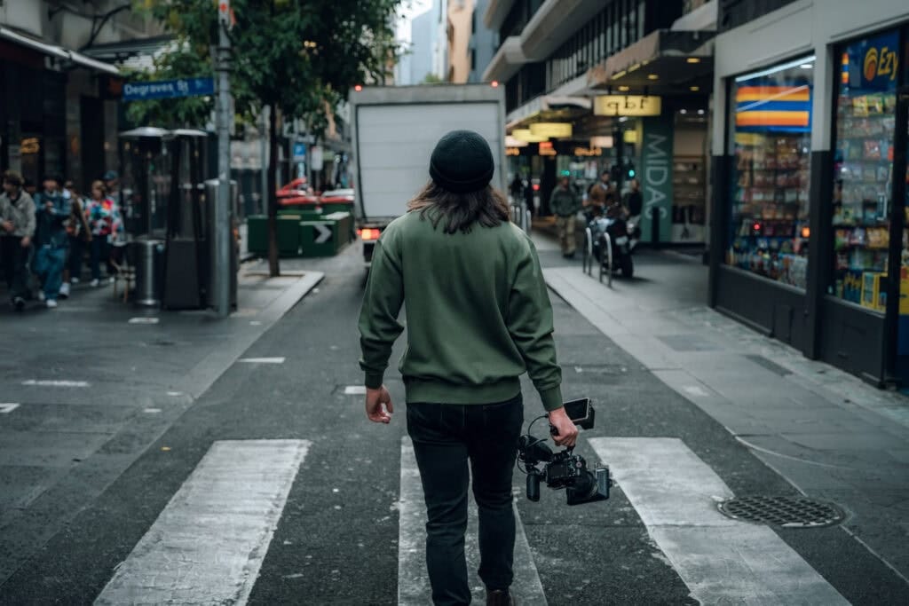 dymon creative services – close-up of filmmaker walking away after a shot