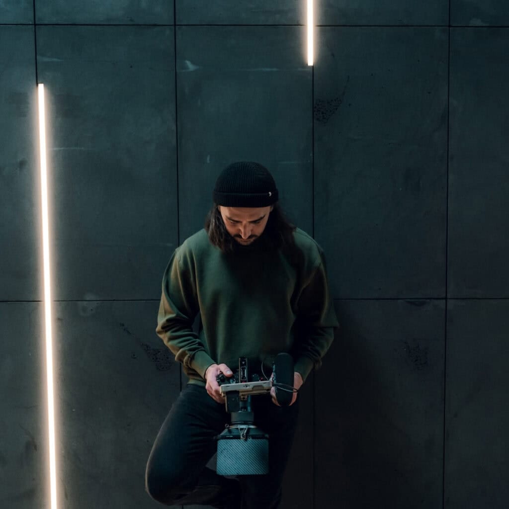 Cinematic Video & Photography Services - dymon creative – reviewing video footage in cinematic lighting.